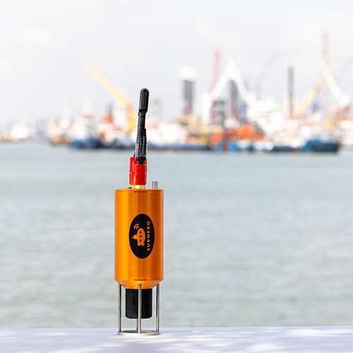 Subnero M25M Series multi-receiver acoustic smart modem deployed outdoors with a harbor in the background, showing its dual-channel antenna setup