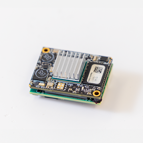 Subnero Gen4x co-processor module rotated to show its heatsink and corner mounting holes for integration inside the modem housing